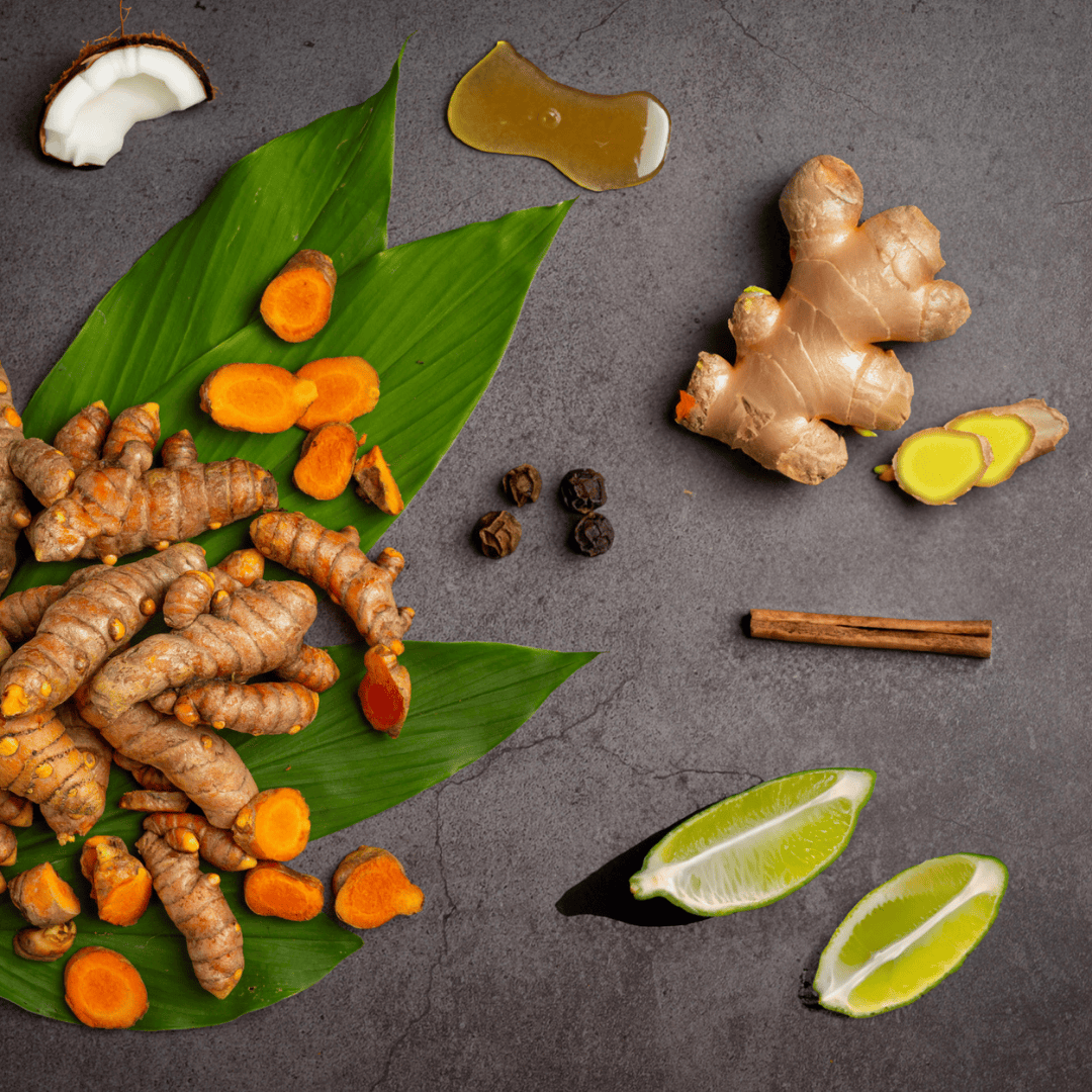 Fresh turmeric, ginger, lime, honey, peppercorns, and cinnamon ingredients for a health-boosting jamu tonic